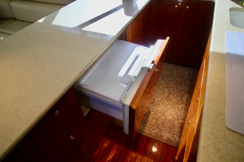 Slide: The Image of Interior of 2004 Sculley Custom Carolina 58' Sportfish with open drawer and elegant wood finish. - 33