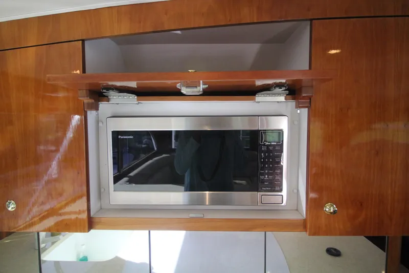 Slide: The Image of Built-in microwave in Sculley Custom Carolina 58' Sportfish yacht, 2004 model, with wooden cabinetry. - 34
