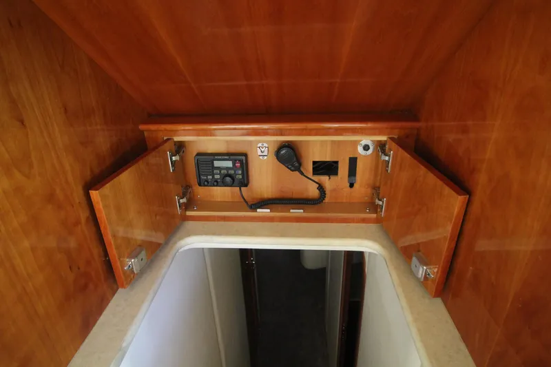Slide: The Image of 2004 Sculley Custom Carolina 58' Sportfish interior with wooden cabinetry and communication equipment. - 38