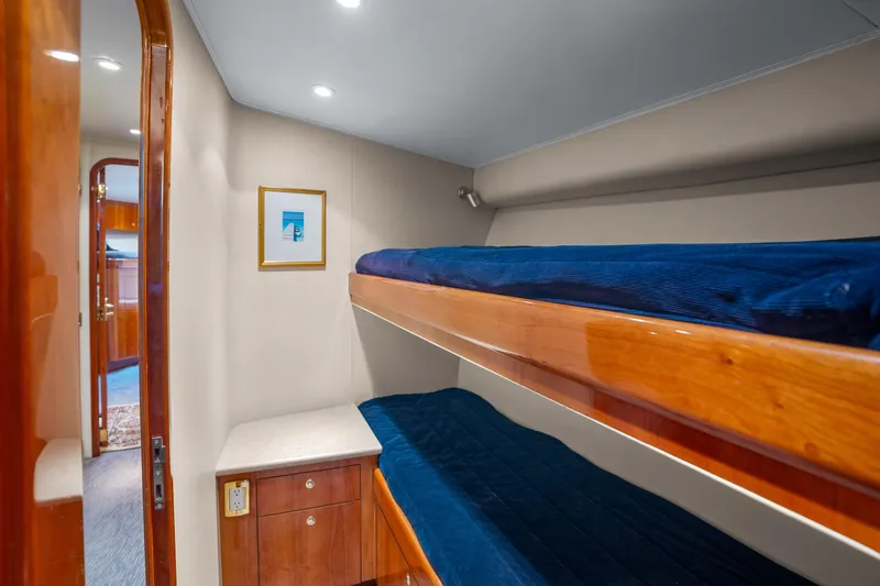 Slide: The Image of Interior of 2004 Sculley Custom Carolina 58' Sportfish with cozy bunk beds and wooden cabinetry. - 40