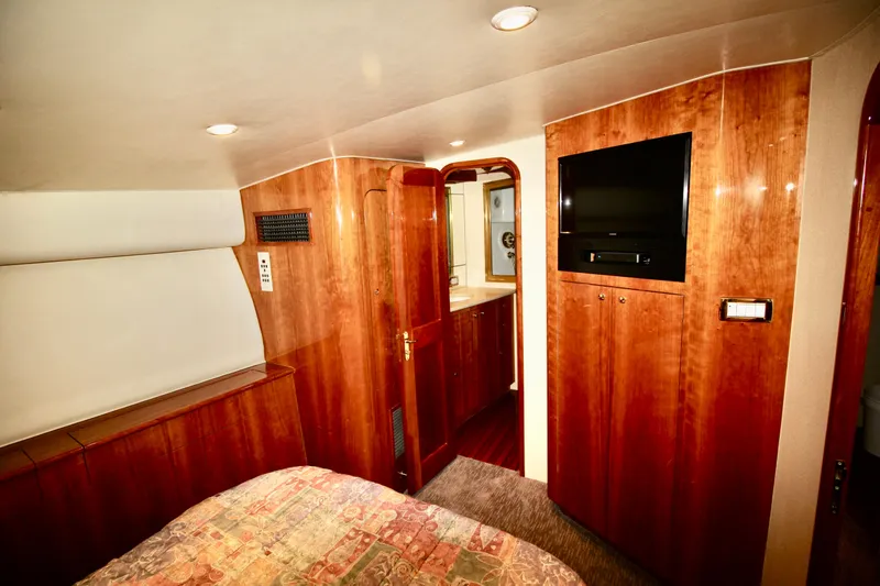 Slide: The Image of Luxurious cabin interior of 2004 Sculley Custom Carolina 58' Sportfish with wood paneling and TV. - 45