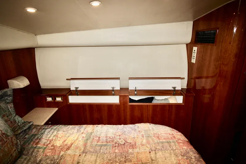 Slide: The Image of Interior cabin of 2004 Sculley Custom Carolina 58' Sportfish with wood paneling and storage. - 48