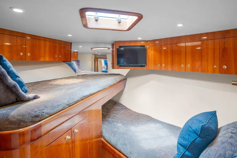 Slide: The Image of Luxurious cabin interior of 2004 Sculley Custom Carolina 58' Sportfish with wood finishes and cozy bedding. - 51