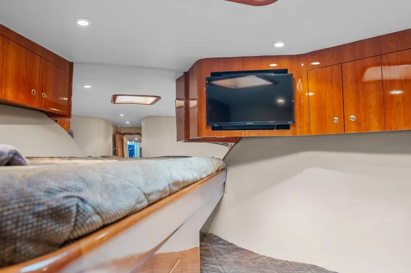 Slide: The Image of Luxurious cabin interior of 2004 Sculley Custom Carolina 58' Sportfish with TV and wood cabinets. - 53