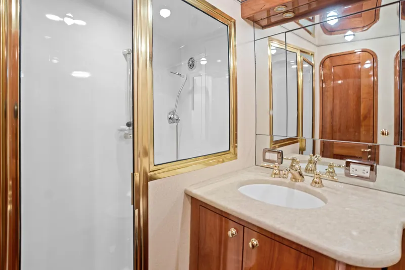 Slide: The Image of Luxurious bathroom in 2004 Sculley Custom Carolina 58' Sportfish yacht with gold fixtures and mirrored cabinets. - 55