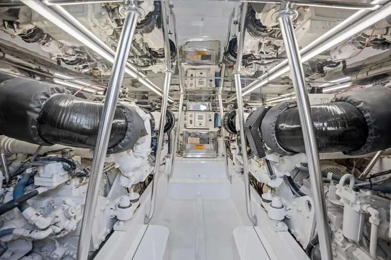 Slide: The Image of Engine room of 2004 Sculley Custom Carolina 58' Sportfish, showcasing dual engines and mechanical systems. - 59