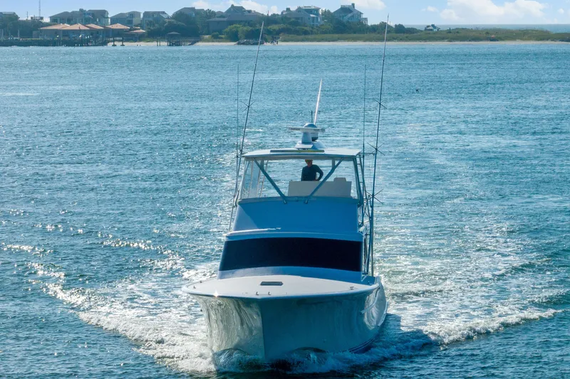 Slide: The Image of 2004 Sculley Custom Carolina 58' Sportfish cruising on open water. - 6