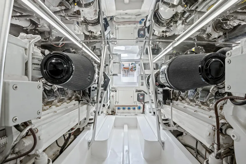 Slide: The Image of Engine room of 2004 Sculley Custom Carolina 58' Sportfish, showcasing dual engines and mechanical systems. - 60