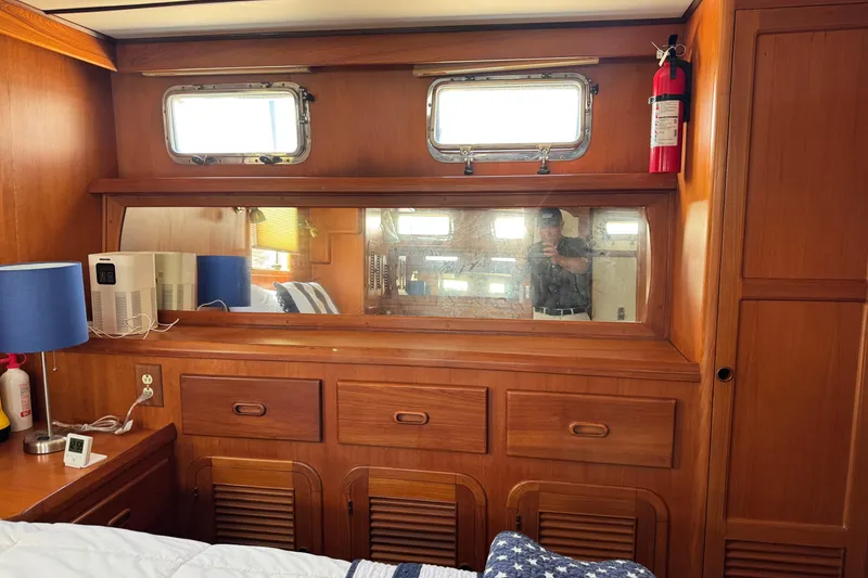 Slide: The Image of Interior of 1999 Heritage East Sundeck 36 with wooden cabinetry and nautical decor. - 11