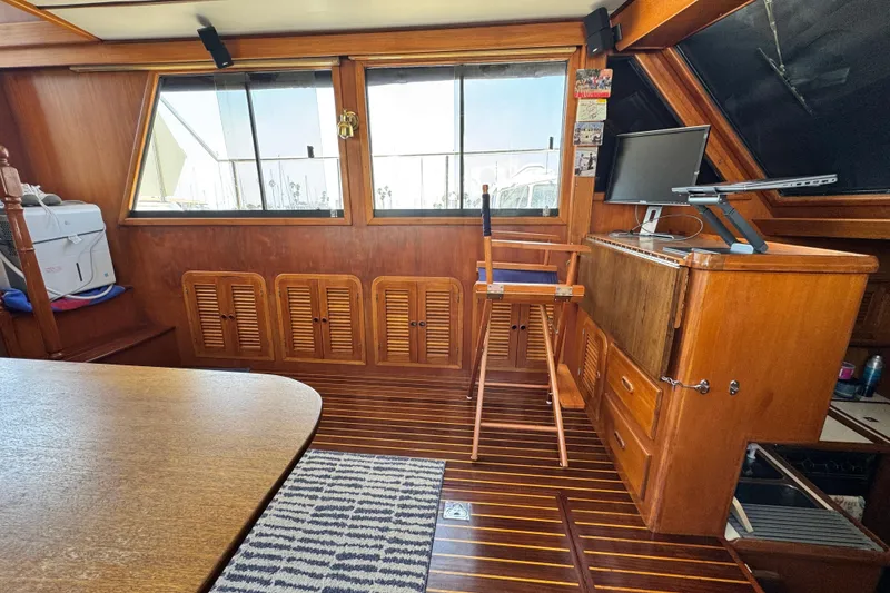 Slide: The Image of Interior of 1999 Heritage East Sundeck 36 yacht with wooden furnishings and nautical decor. - 14