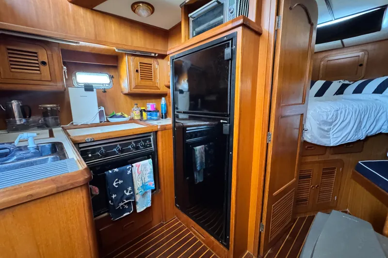 Slide: The Image of 1999 Heritage East Sundeck 36 interior with kitchen and cozy sleeping area. - 19