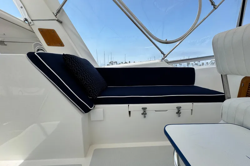 Slide: The Image of Interior of 1999 Heritage East Sundeck 36 with navy seating and white accents. - 26