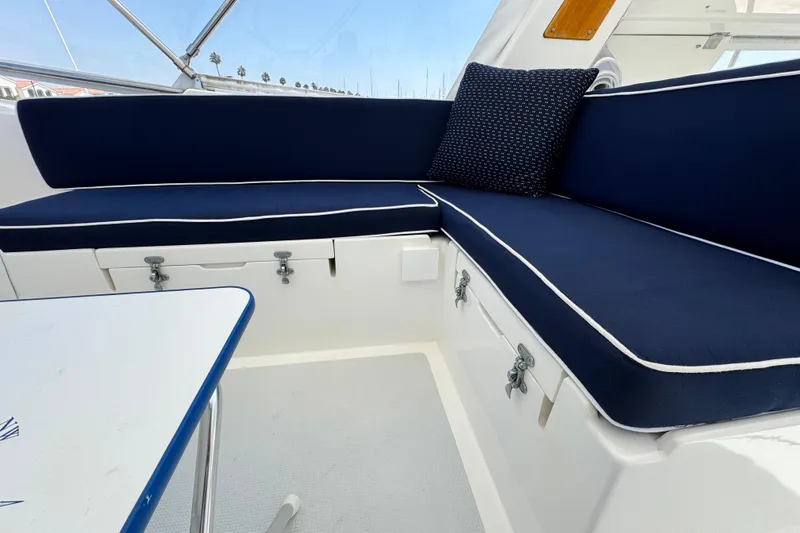 Slide: The Image of 1999 Heritage East Sundeck 36 interior with navy seating and white trim. - 27