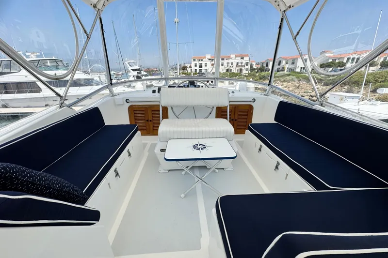 Slide: The Image of 1999 Heritage East Sundeck 36 interior with navy seating and a nautical-themed table. - 30