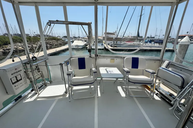 Slide: The Image of 1999 Heritage East Sundeck 36 yacht interior with seating and marina view. - 34