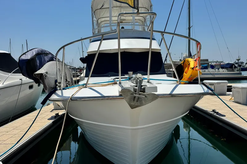 Slide: The Image of 1999 Heritage East Sundeck 36 yacht docked at marina, front view. - 40