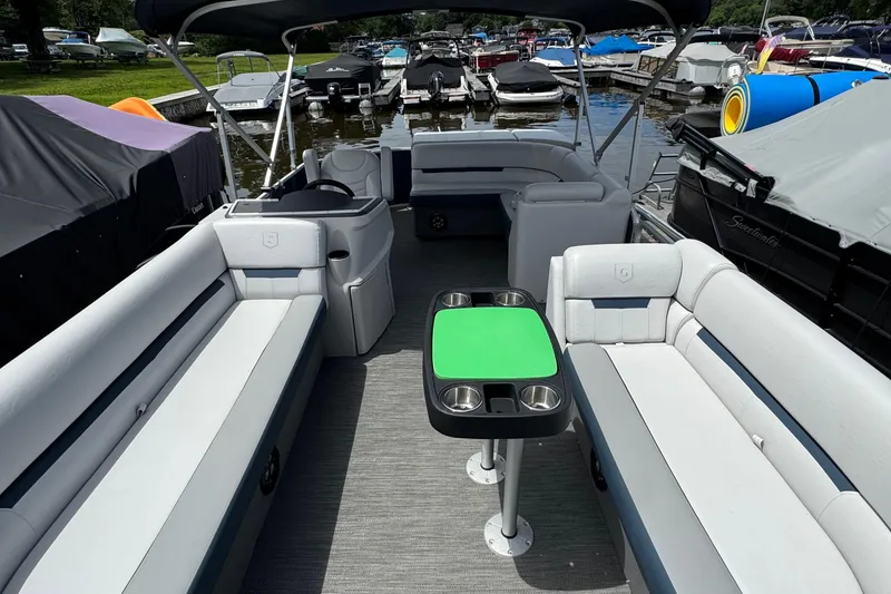 Slide: The Image of 2022 Godfrey Sweetwater 2186 C pontoon boat with spacious seating and green table. - 3