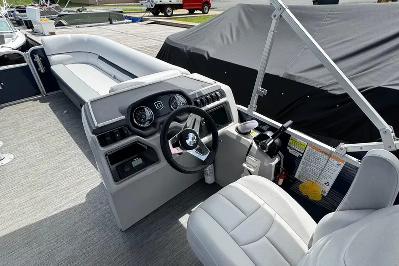 Slide: The Image of Interior of a 2022 Godfrey Sweetwater 2186 C pontoon boat, featuring a modern helm and seating. - 6