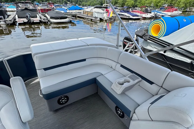 Slide: The Image of 2022 Godfrey Sweetwater 2186 C pontoon boat with spacious seating at a marina. - 7