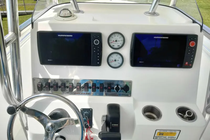 Slide: The Image of Boat dashboard of 2017 Release 208RX with dual Humminbird displays and controls. - 10
