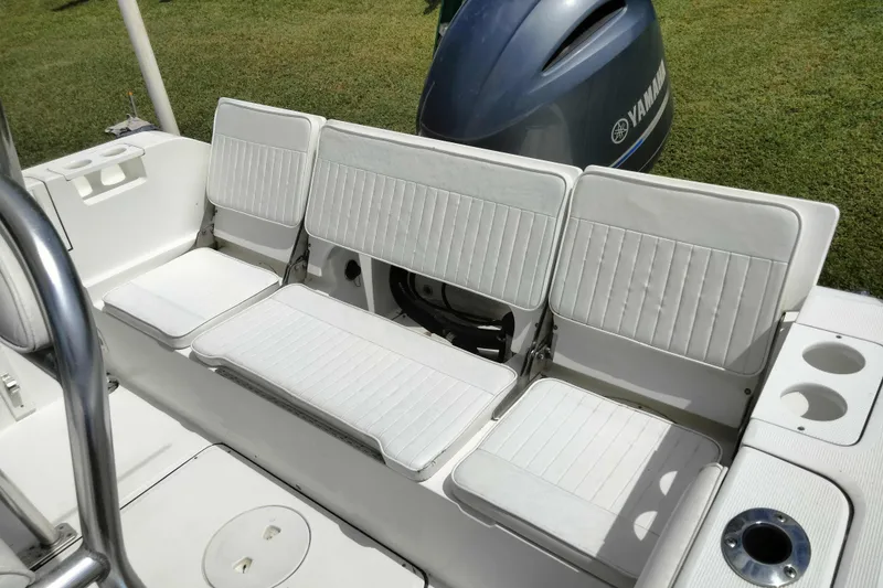 Slide: The Image of White seating on 2017 Release 208RX boat with Yamaha engine in background. - 13