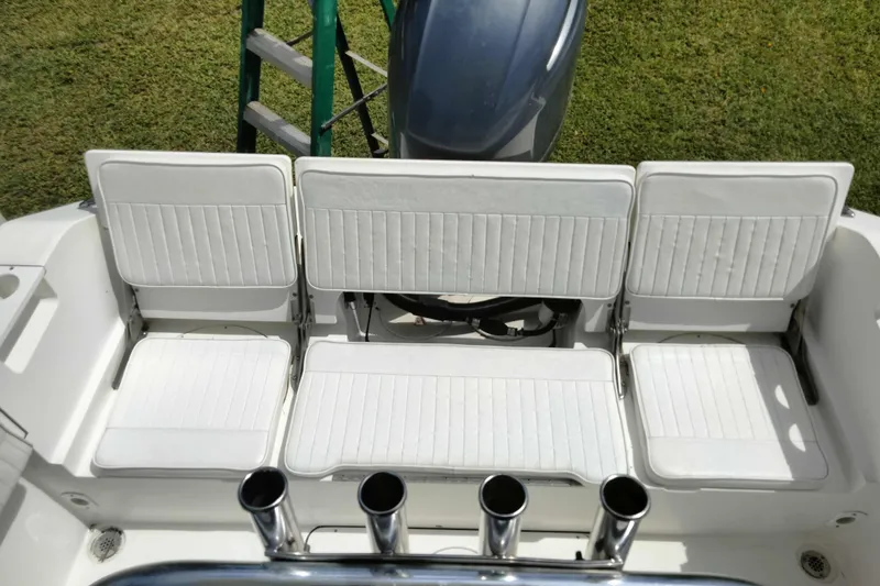 Slide: The Image of White seating on a 2017 Release 208RX boat with rod holders and engine view. - 14