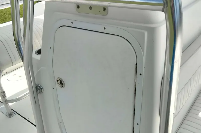 Slide: The Image of White compartment door on a 2017 Release 208RX boat interior. - 16