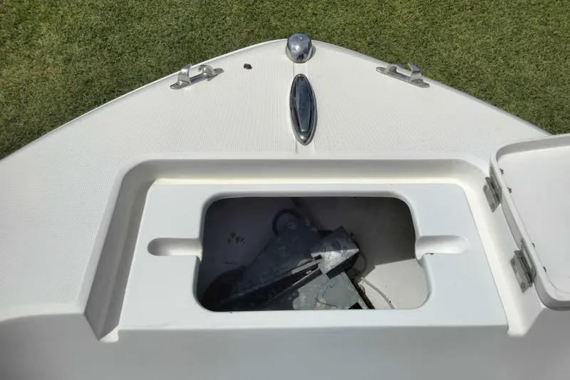 Slide: The Image of Open anchor compartment on 2017 Release 208RX boat, showing anchor storage. - 19