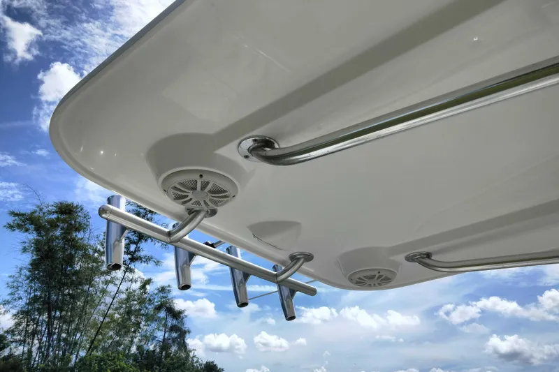 Slide: The Image of 2017 Release 208RX boat underside with rod holders and speakers against blue sky. - 23