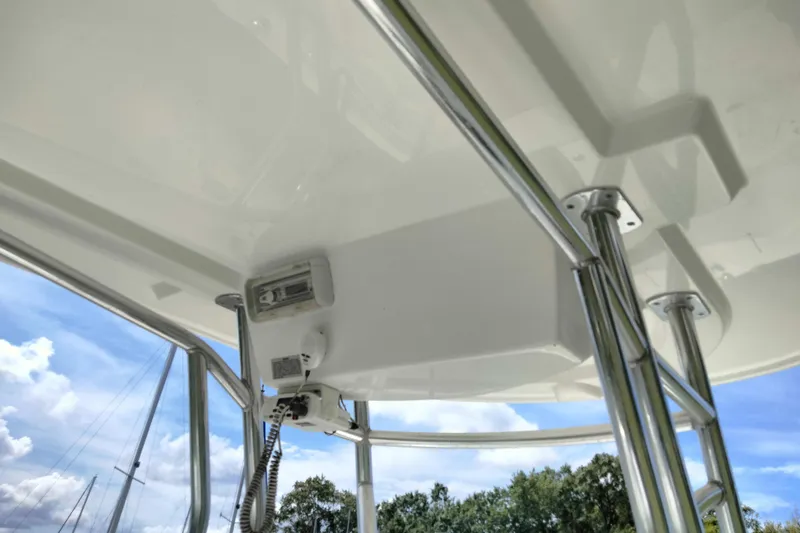 Slide: The Image of 2017 Release 208RX boat canopy with stainless steel supports under clear sky. - 24