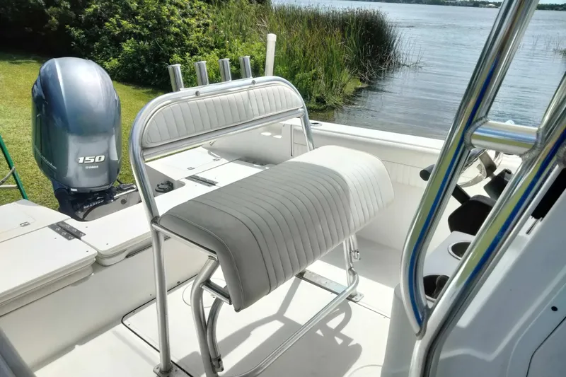 Slide: The Image of 2017 Release 208RX boat interior with Yamaha 150 engine by a lake. - 25