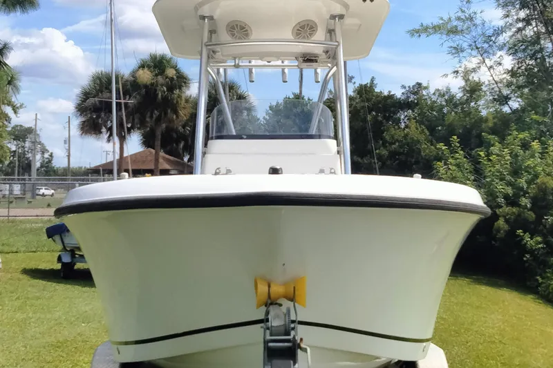 Slide: The Image of 2017 Release 208RX boat on trailer, front view, parked on grass. - 3