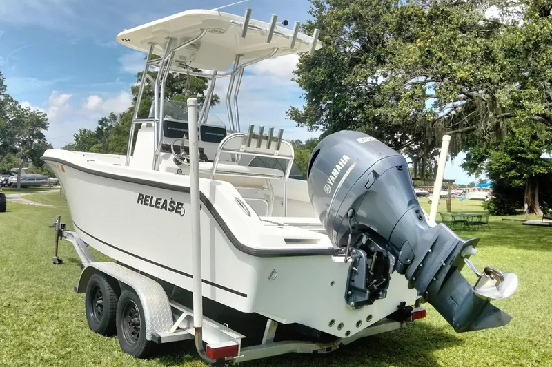 Slide: The Image of 2017 Release 208RX boat on trailer with Yamaha outboard motor, parked on grass. - 5