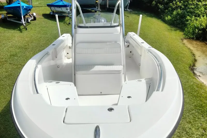 Slide: The Image of 2017 Release 208RX boat on grass, featuring white seating and sleek design. - 7