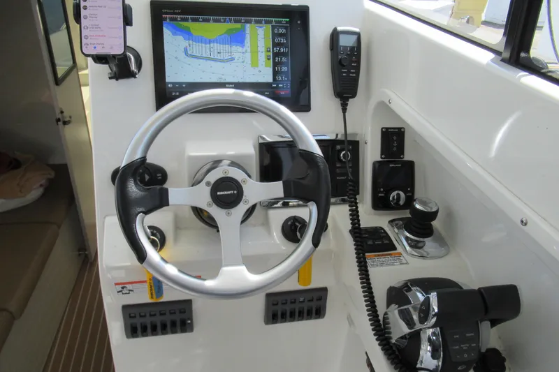 Slide: The Image of Control panel of 2017 Ribcraft Express 32 with steering wheel and navigation display. - 10