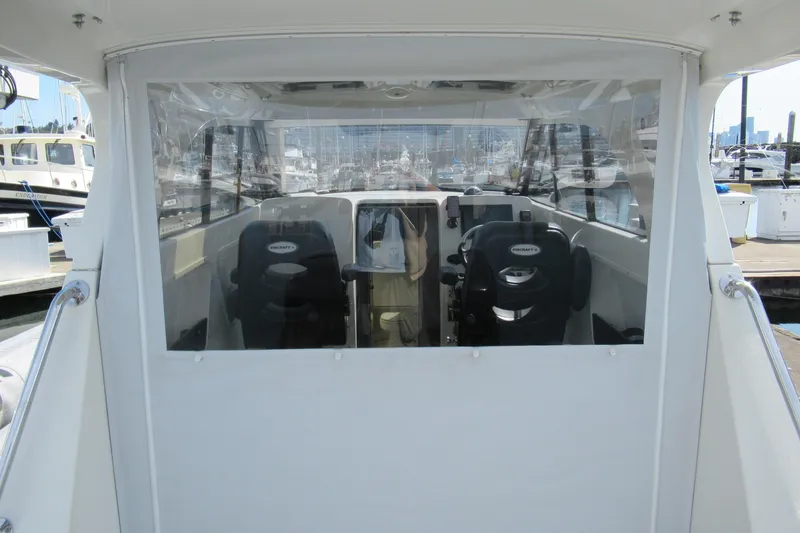 Slide: The Image of 2017 Ribcraft Express 32 boat interior with two seats at a marina. - 15