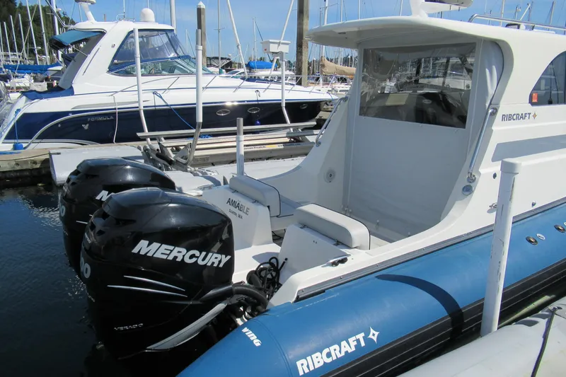 Slide: The Image of 2017 Ribcraft Express 32 with twin Mercury engines docked at a marina. - 6