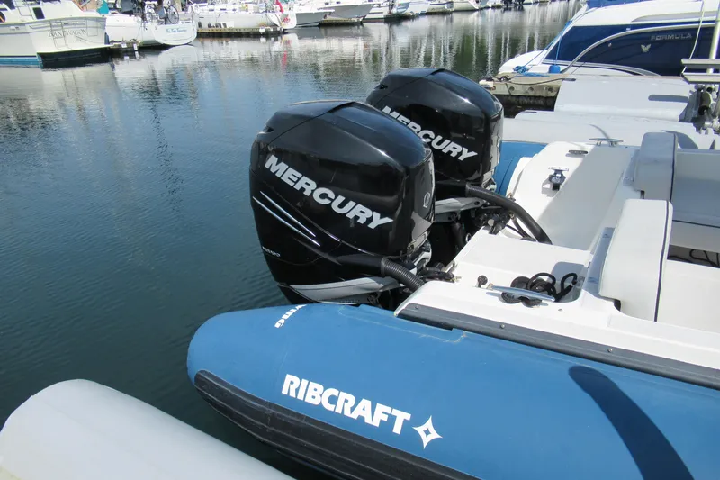 Slide: The Image of 2017 Ribcraft Express 32 with dual Mercury outboard engines docked at marina. - 7
