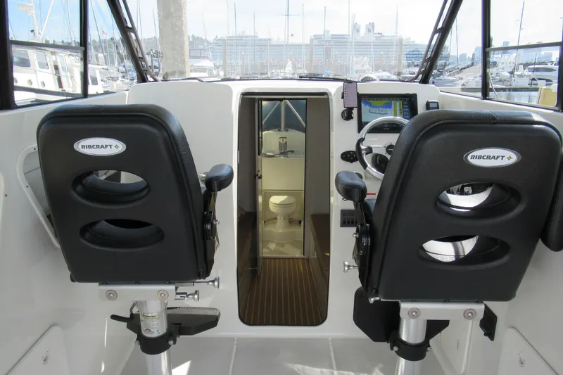 Slide: The Image of 2017 Ribcraft Express 32 boat interior with helm seats and navigation equipment. - 9