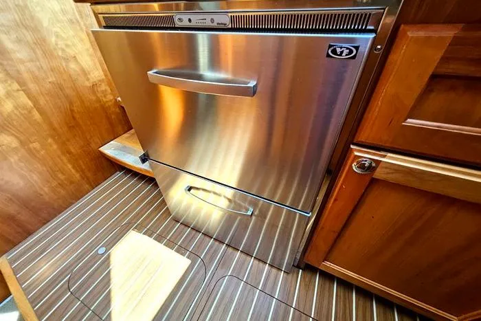Slide: The Image of Stainless steel refrigerator in 2007 Mainship 34 Trawler's wooden interior kitchen. - 14