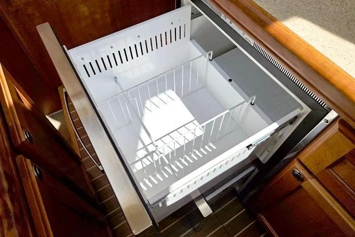 Slide: The Image of Open drawer in 2007 Mainship 34 Trawler kitchen, featuring organized storage space. - 16