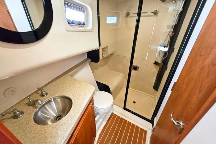 Slide: The Image of Bathroom of 2007 Mainship 34 Trawler with sink, toilet, and shower. - 18