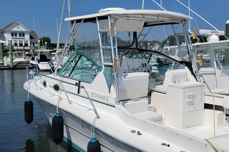 Slide: The Image of 2000 Stamas 310 Express boat docked at marina, featuring sleek design and spacious cockpit. - 1