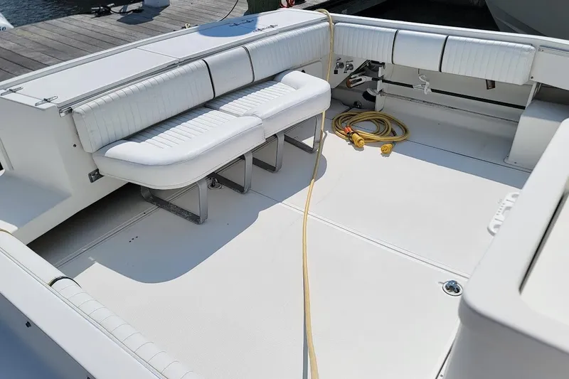 Slide: The Image of 2000 Stamas 310 Express boat interior with white seating and coiled yellow cable. - 13