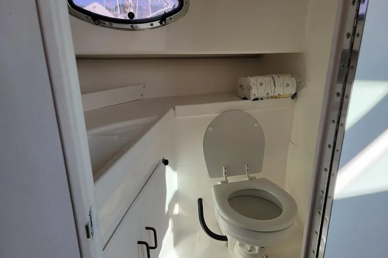 Slide: The Image of 2000 Stamas 310 Express boat bathroom with toilet and porthole window. - 19