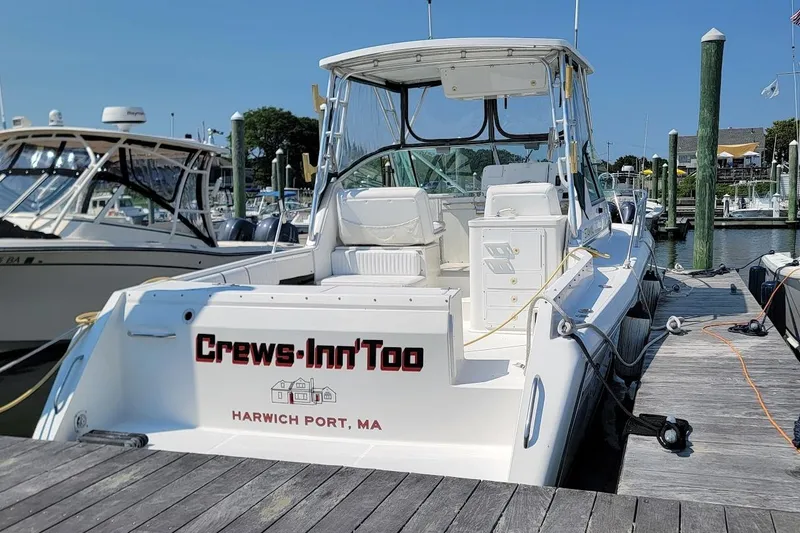 Slide: The Image of 2000 Stamas 310 Express boat docked at Harwich Port, MA marina. - 2