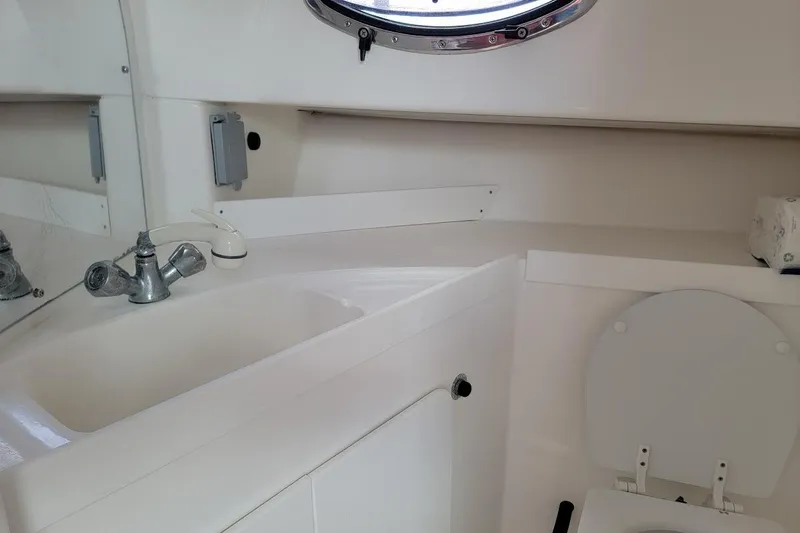 Slide: The Image of 2000 Stamas 310 Express boat bathroom with sink, faucet, and toilet. - 20