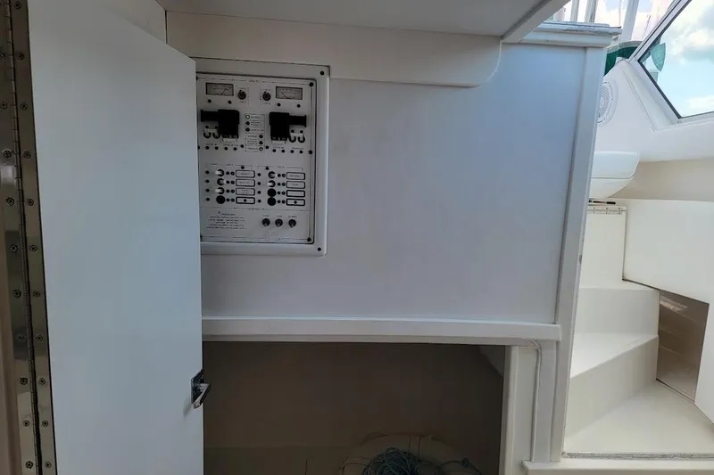 Slide: The Image of 2000 Stamas 310 Express boat interior with control panel and open storage compartment. - 23