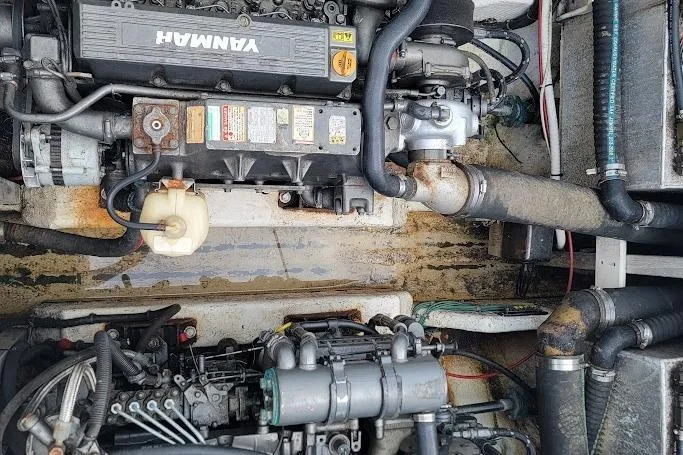 Slide: The Image of Engine compartment of a 2000 Stamas 310 Express boat with Yanmar engine components. - 25