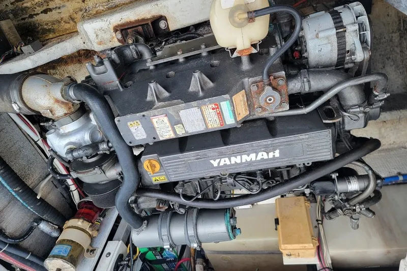 Slide: The Image of Engine of a 2000 Stamas 310 Express boat, featuring a Yanmar diesel engine. - 26